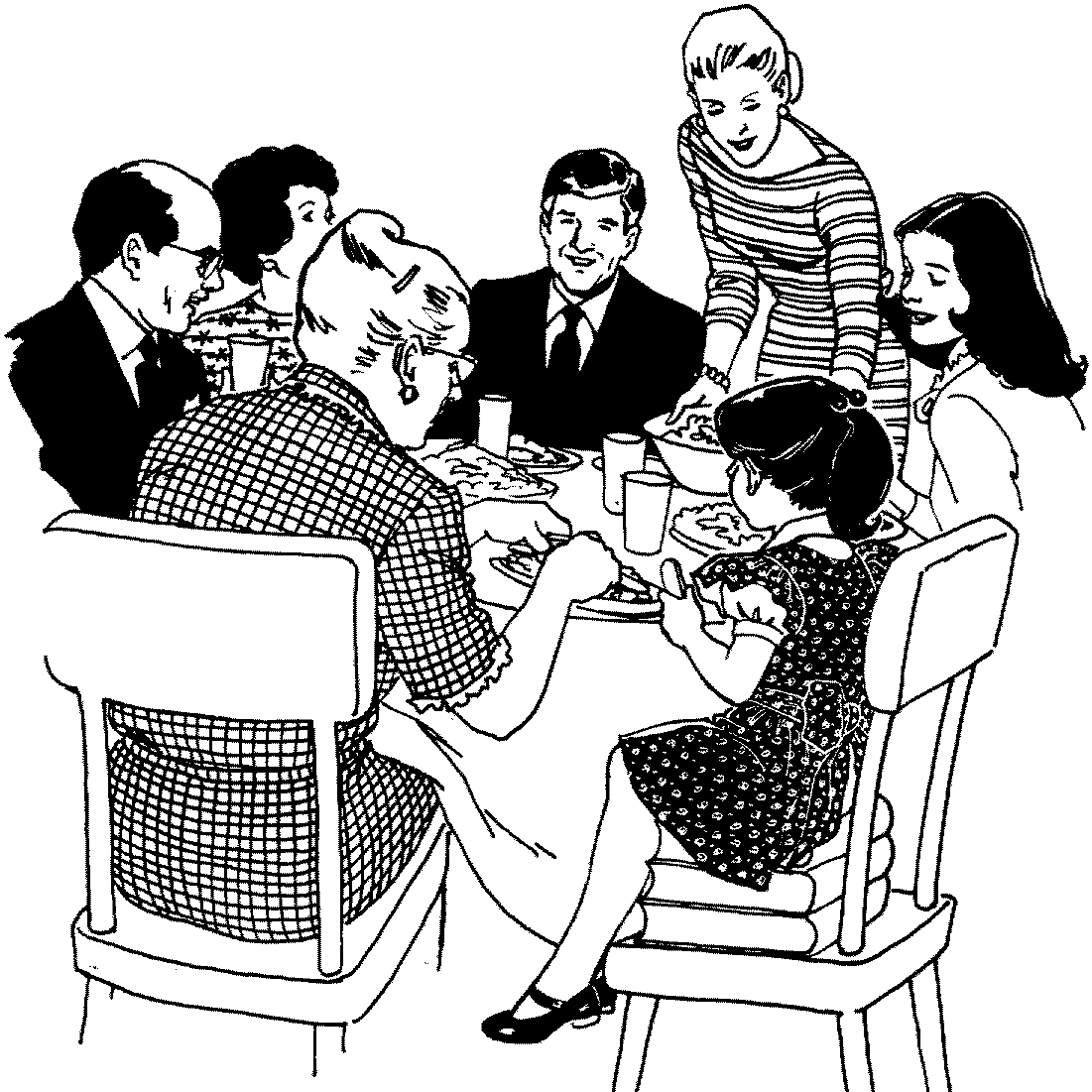 a family sits around the table at a holiday dinner and a young girl sits on a stack of books so she can reach the table